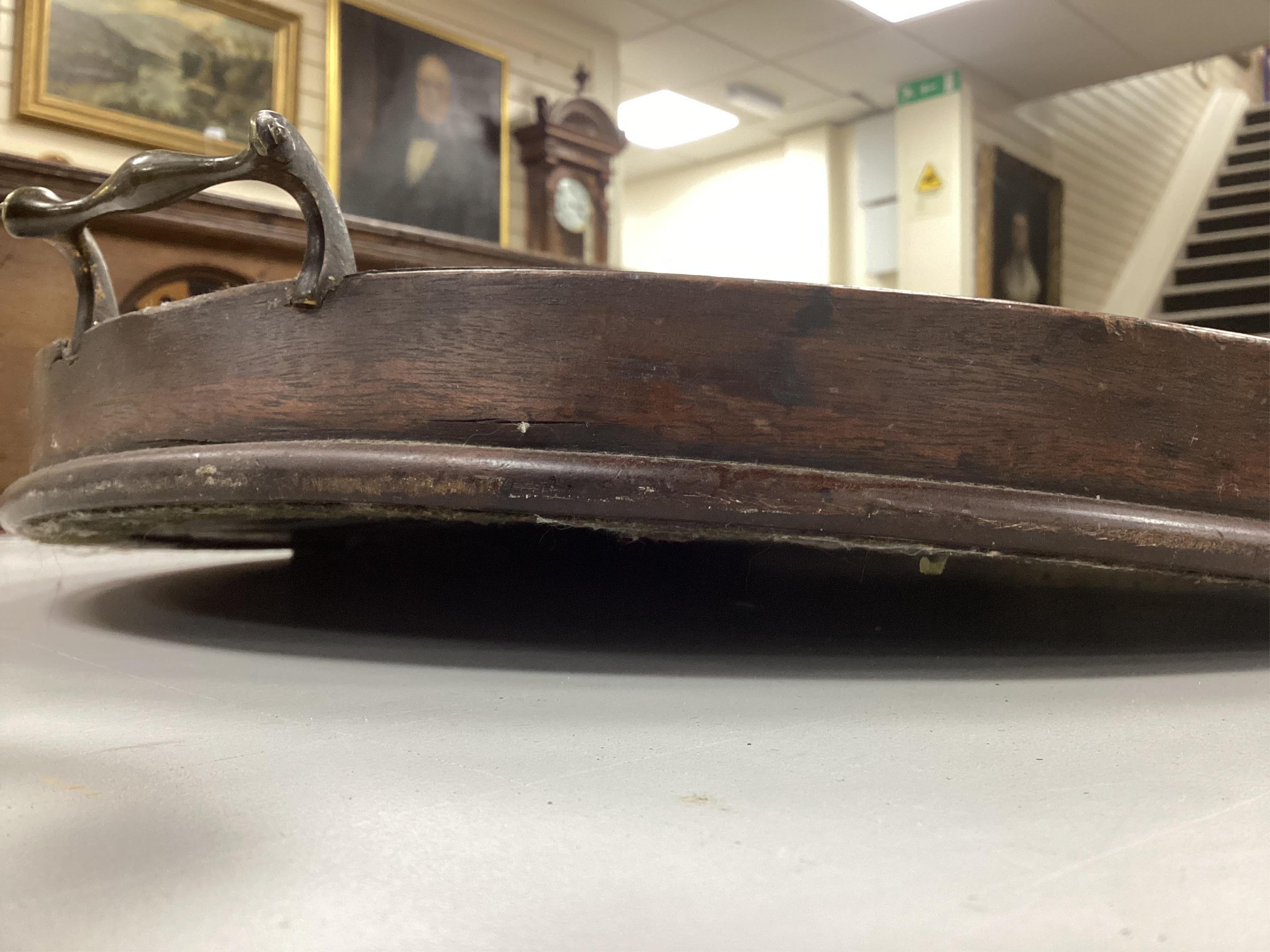 A Georgian oval mahogany two handled tea tray, width 73cm, depth 52cm. Condition poor, warped